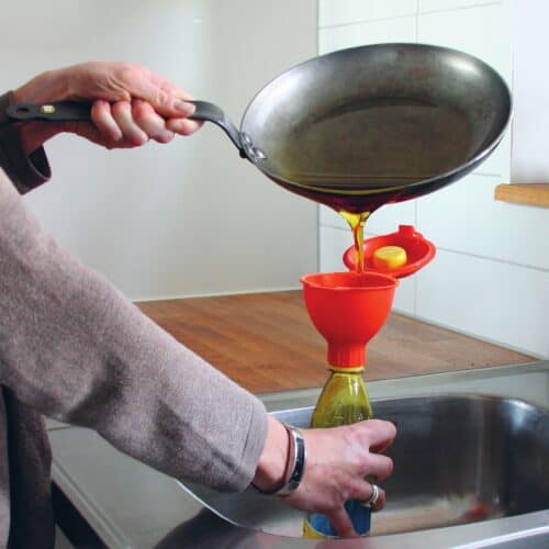Pouring used cooking oil into a funnel